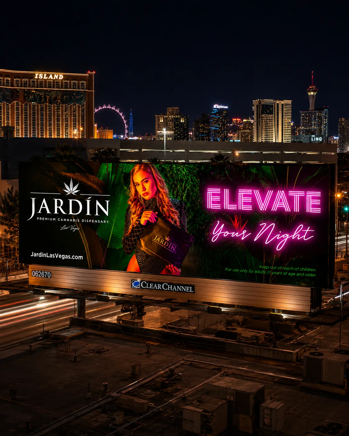 Jardín cannabis dispensary billboard glowing at night above Las Vegas traffic with the Strip skyline behind